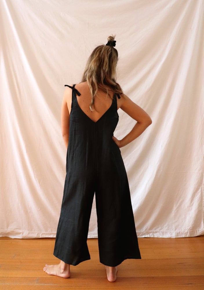 Ethically made black linen jumpsuit with adjustable shoulder tie.