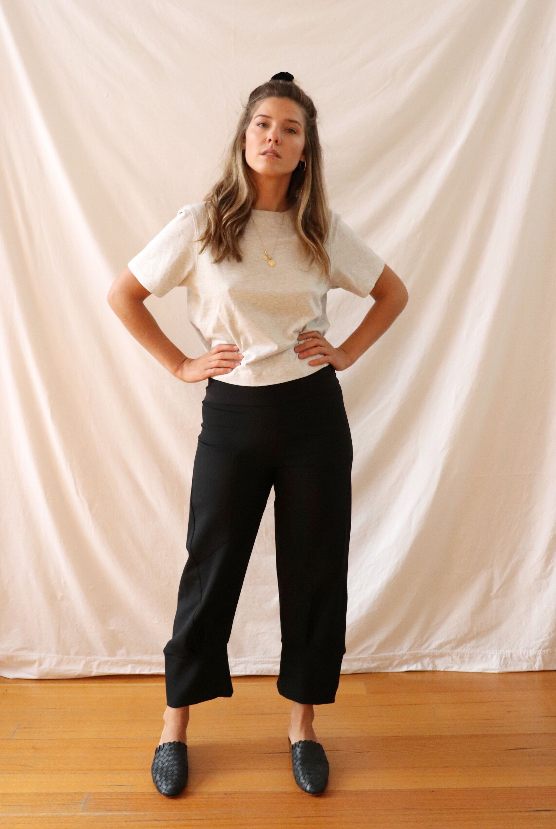 ethically made black stretch pants with pockets and three-quarter cuff.