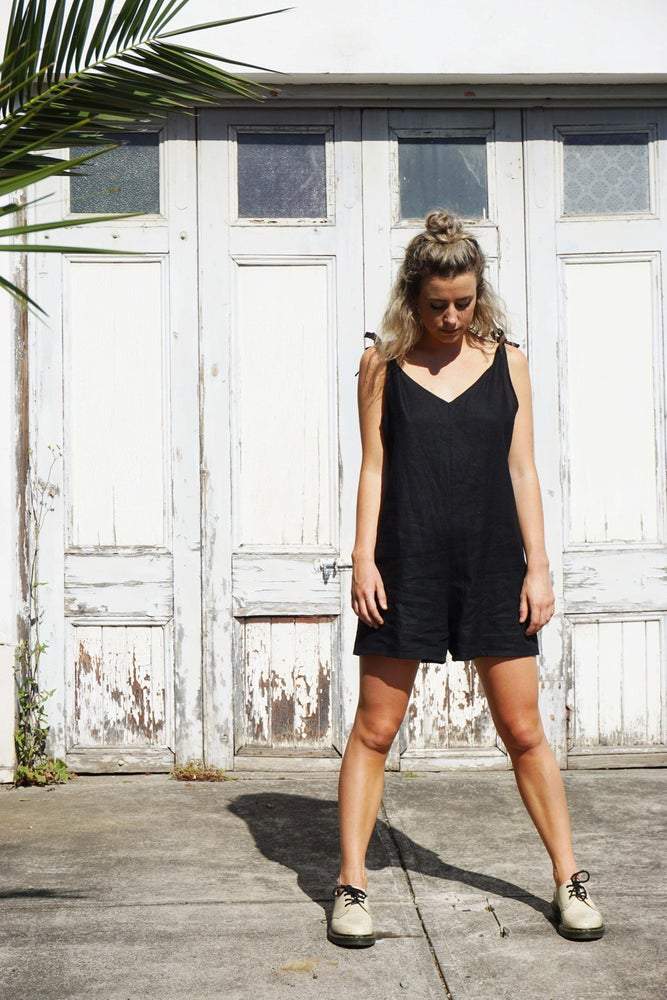 Ethically made black linen short jumpsuit with adjustable shoulder tie.