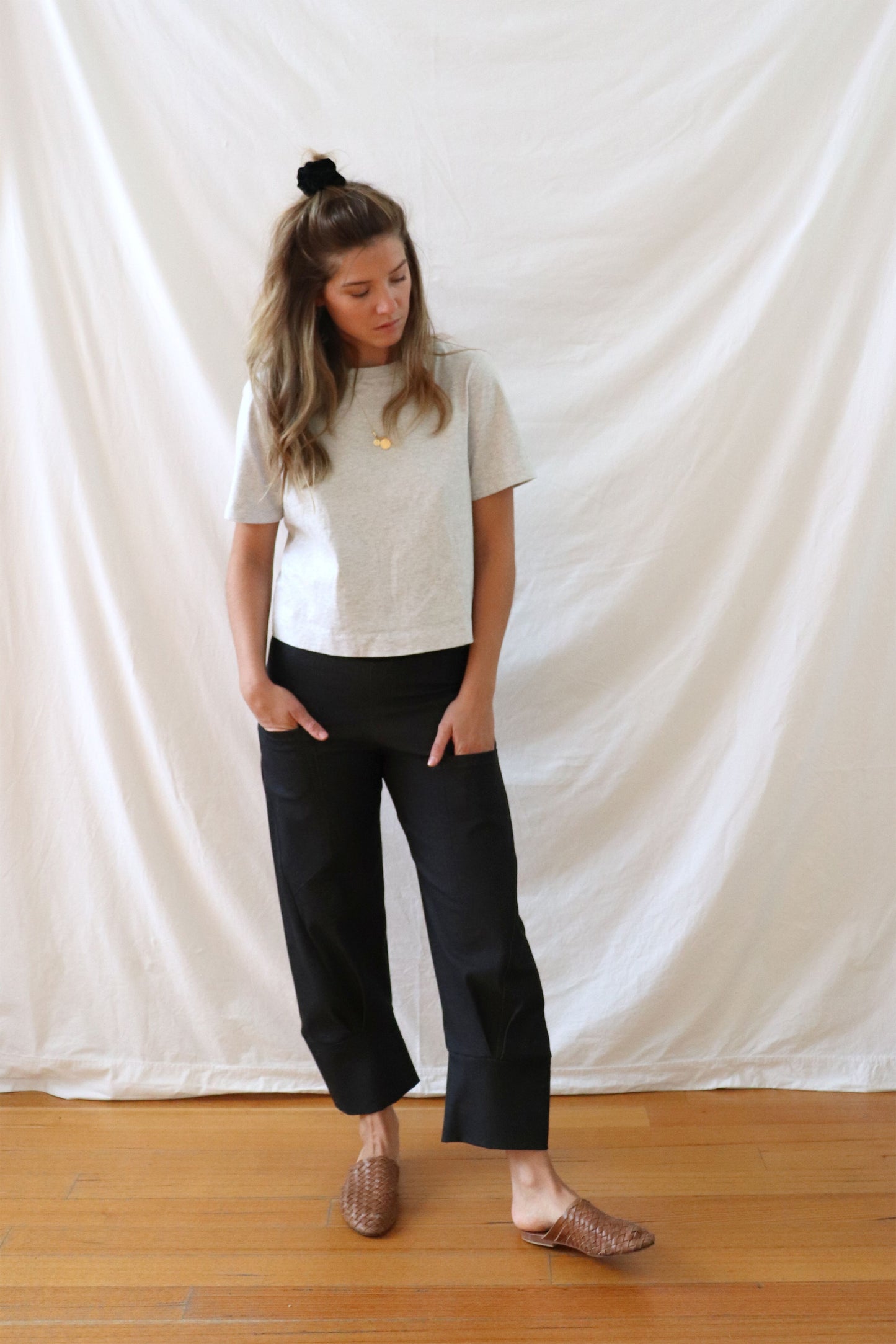 ethically made black stretch pants with pockets and three-quarter cuff.