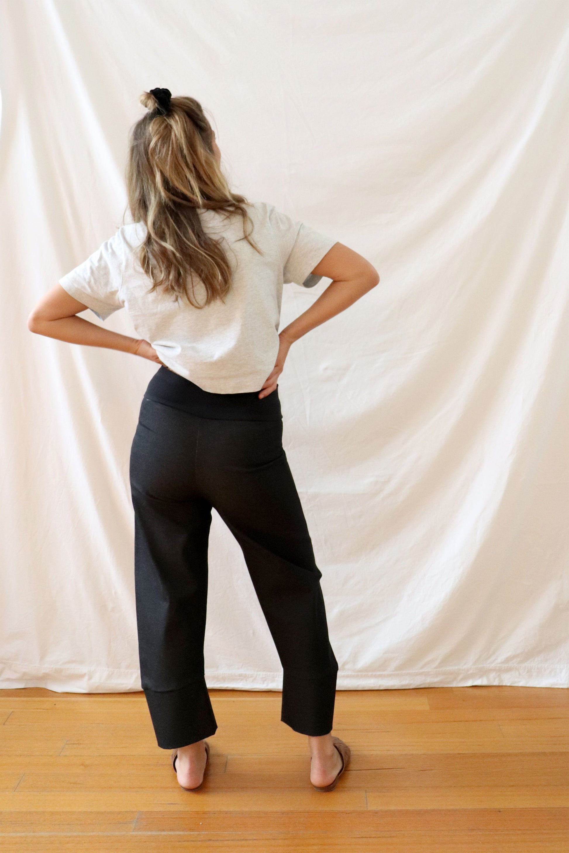 ethically made black stretch pants with pockets and three-quarter cuff.