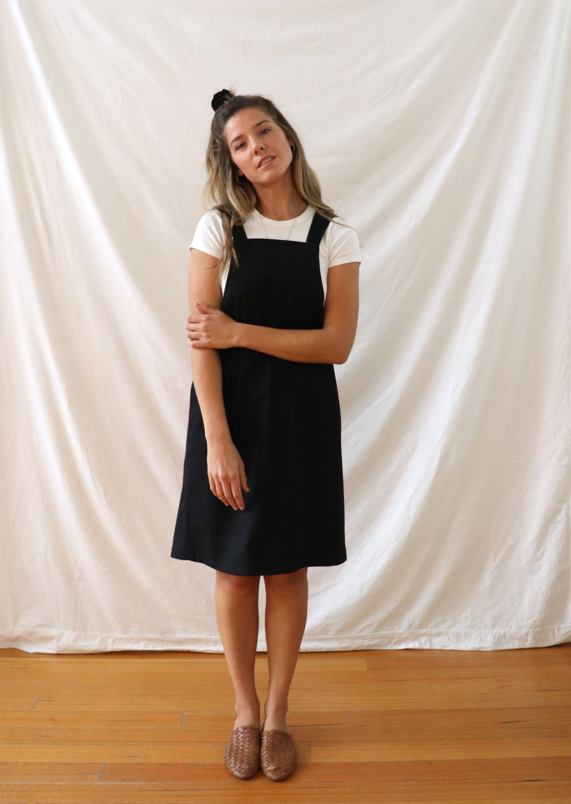 Ethically made pinafore style dress in black linen with one pocket. Mid length and short.