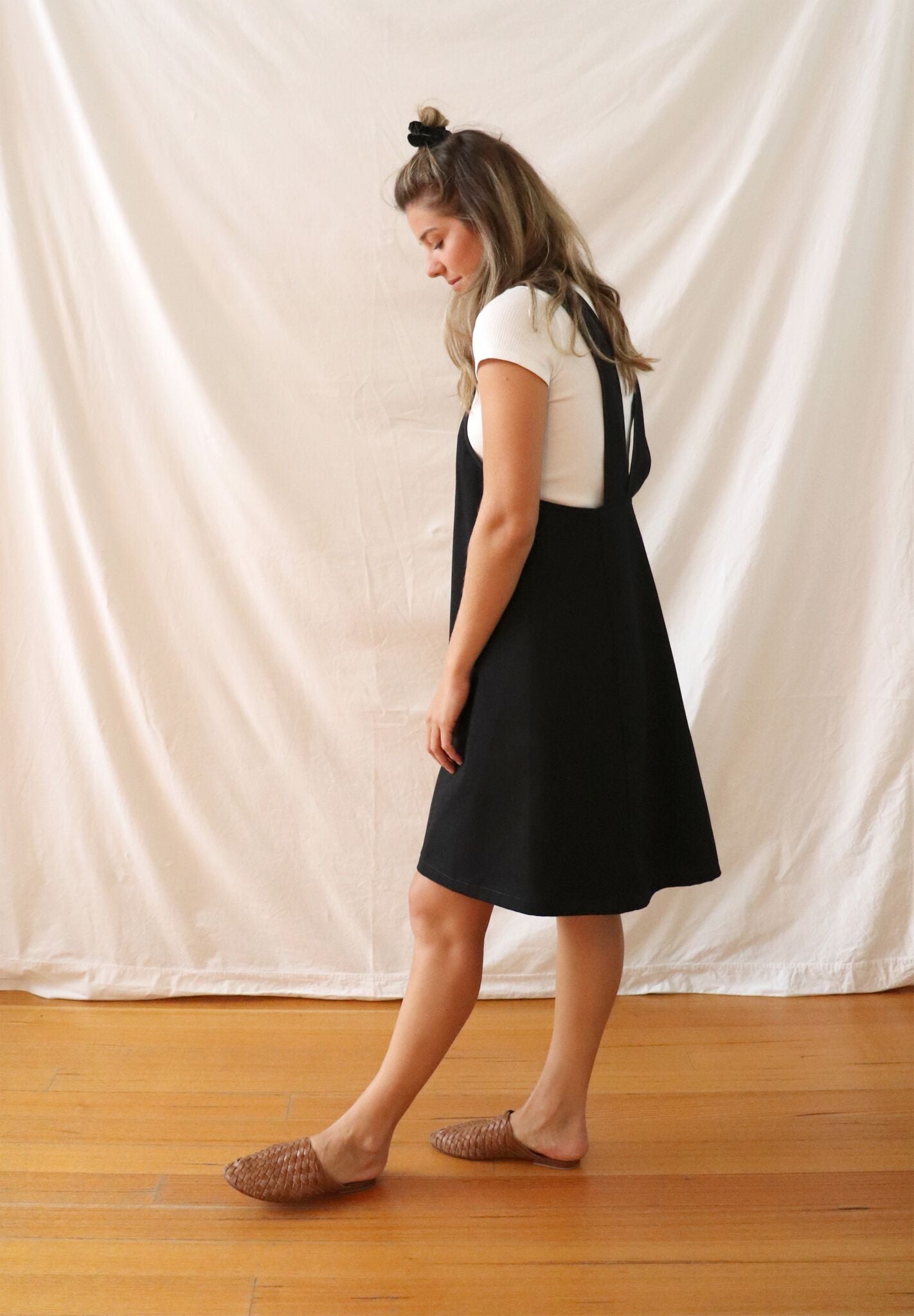 Ethically made pinafore style dress in black linen with one pocket. Mid length and short.